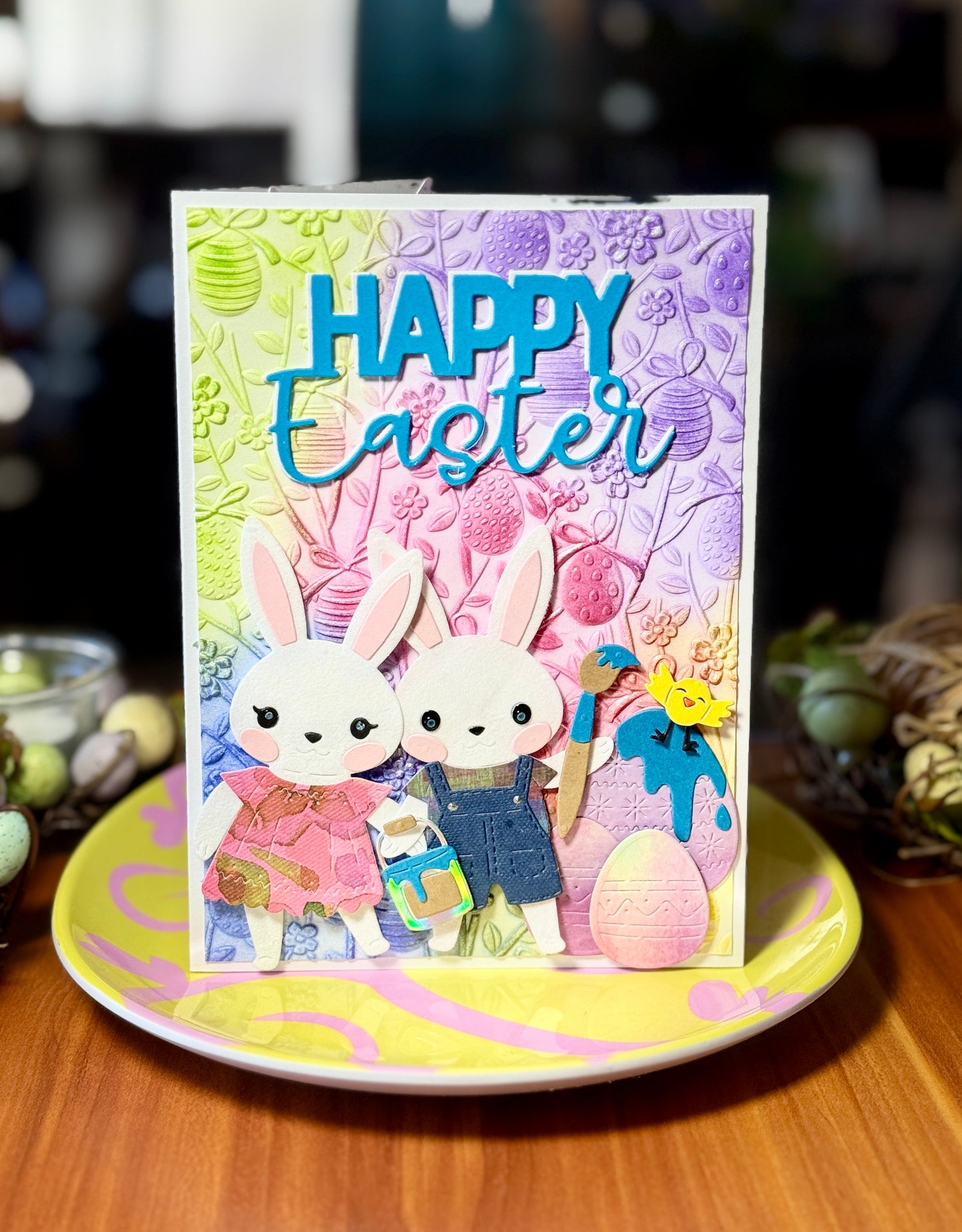 Easter card with two bunnies painting easter eggs together