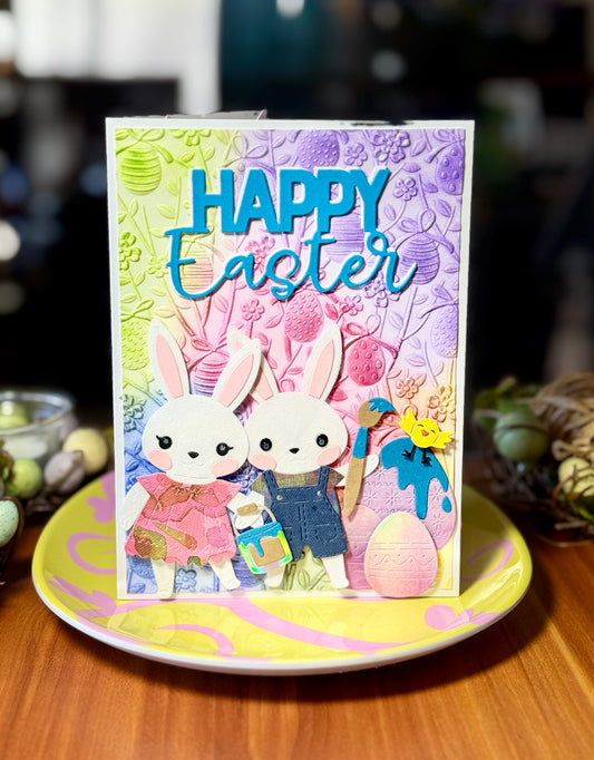 Easter card with two bunnies painting easter eggs together